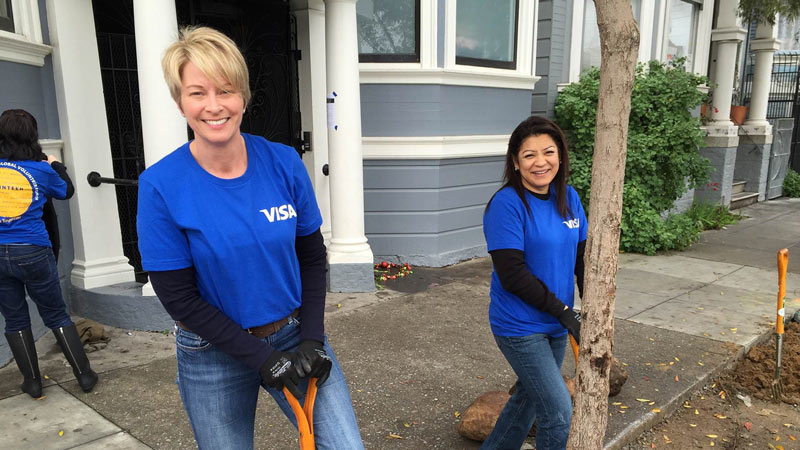 Visa volunteers landscaping in an urban setting.