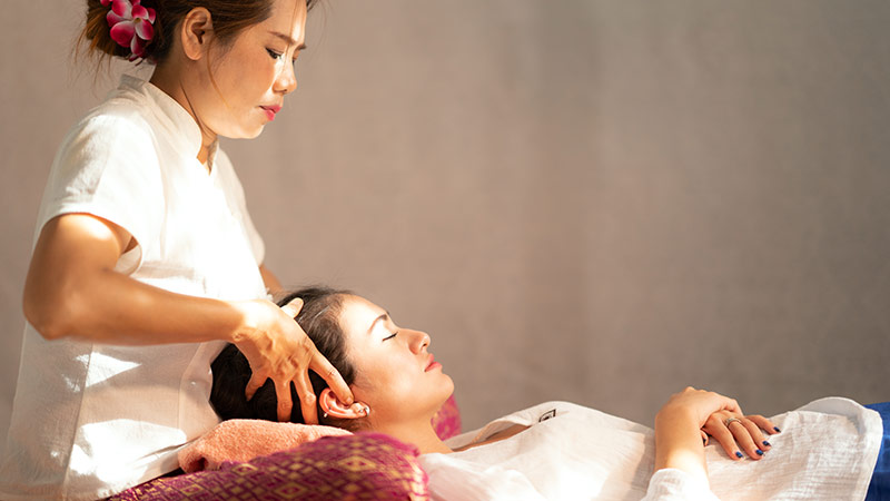 Traveler getting a massage to make her Bangkok trip rejuvenating