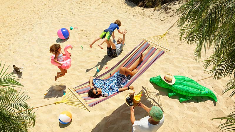 Family on holiday at the beach using Visa travel tips