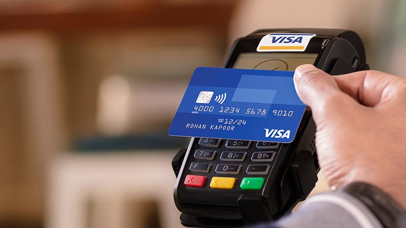 A closeup shot of the Contactless Visa card at a point of sale machine