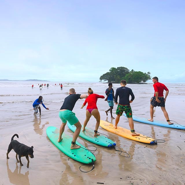 Learning how to surf on a beach