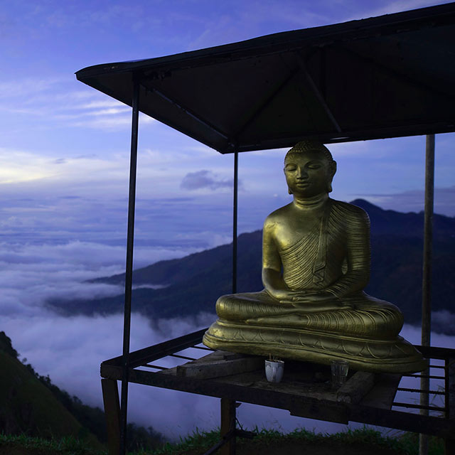 Buddha statue on a mountain peak